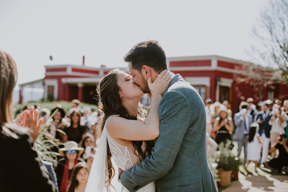 novios beso ceremonia casamiento aire libre