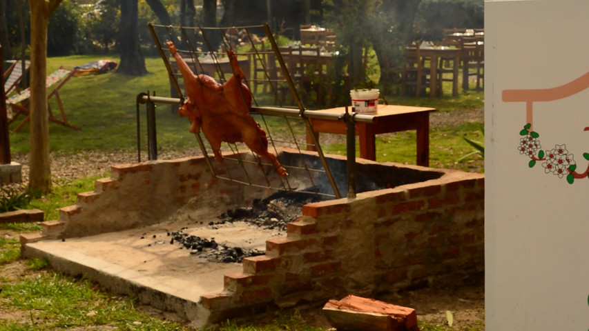 Lechón al spiedo a leña